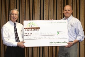 Board member Dr. Tony Foster presents Dr. Thomas Wright from Hope House Free Medical Center with a grant for $3,460.