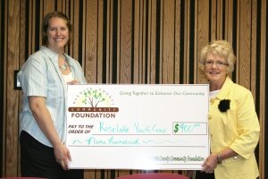 Yo Bellingar, MCCF Board member, presents Amber Kelso from Rose Lake Youth Camp a grant for $900.