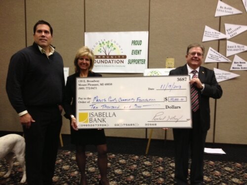 Scott Ruggles representing the Eagle Village Endowment accepts a surprise donation of $10,000 from Keith Kenney and Michelle Bauer from Isabella Bank!!